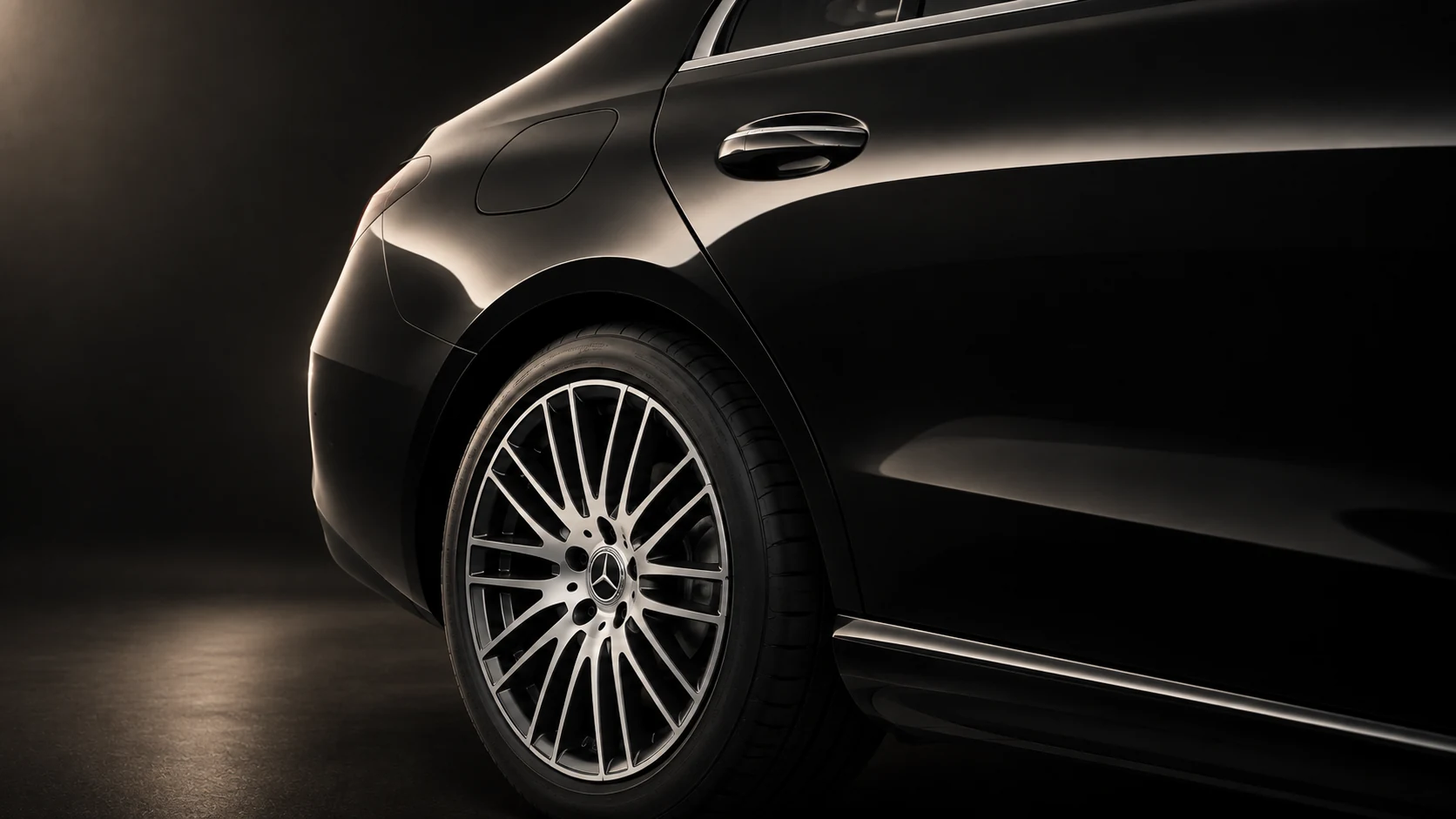 Mercedes-Benz C-Class rear wheel, wheel arch and paint finish detail in dark studio light.