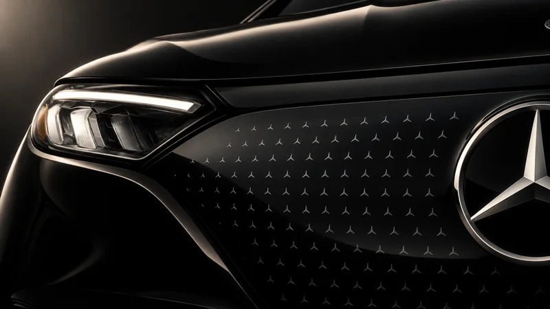 Close-up of a Mercedes-Benz EQE SUV electric front panel, star pattern and headlamp.