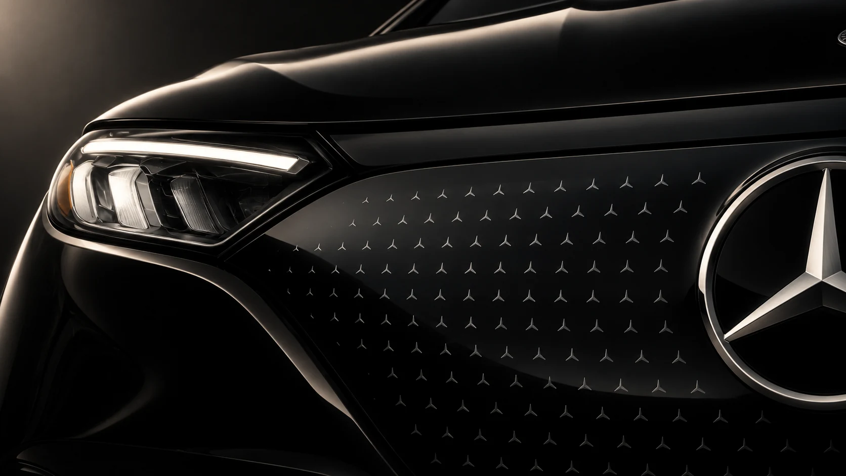 Close-up of a Mercedes-Benz EQE SUV electric front panel, star pattern and headlamp.