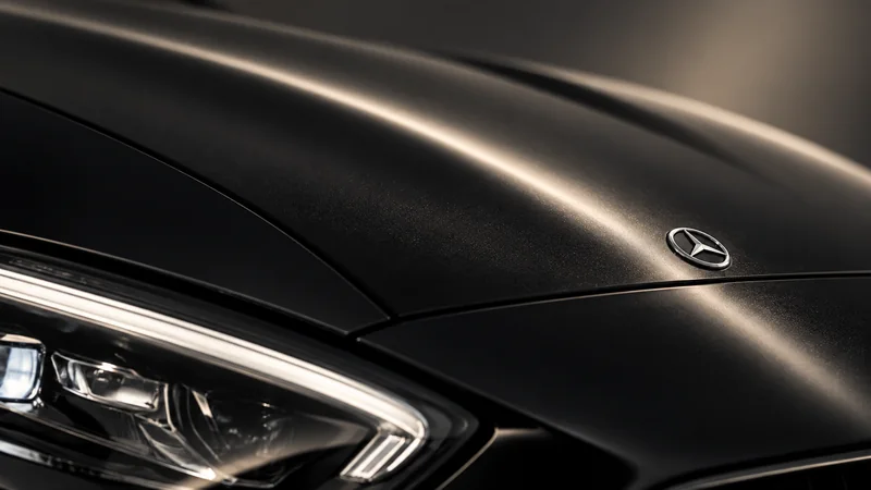 Close-up of a Mercedes-Benz C-Class bonnet badge and headlamp edge.