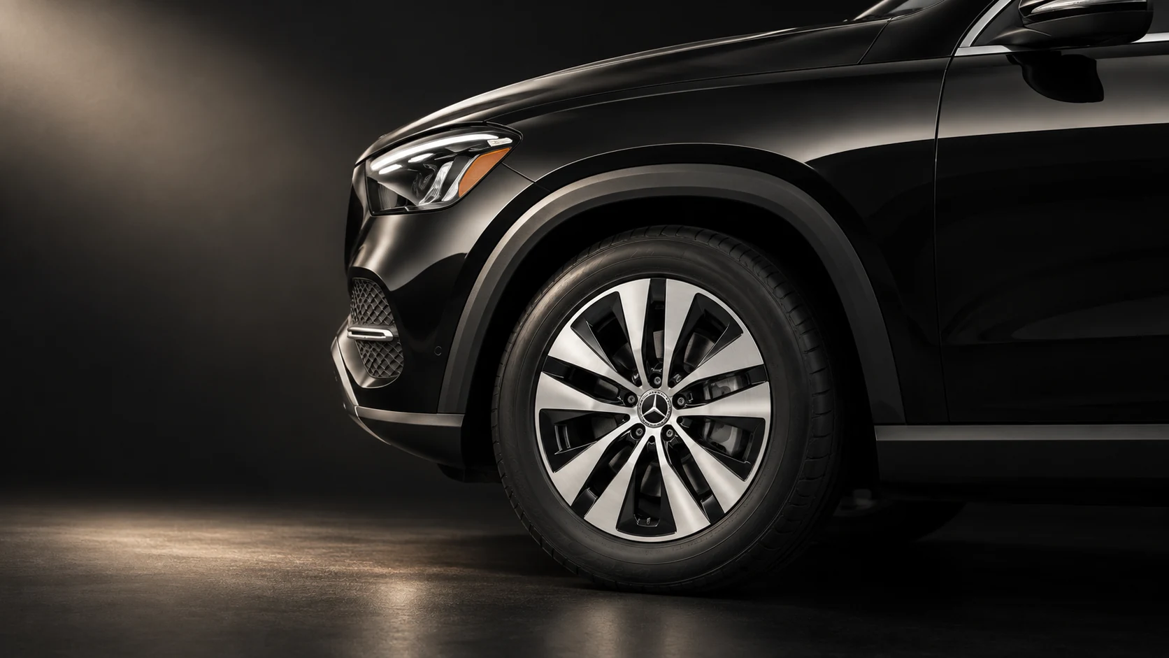 Mercedes-Benz GLE front wheel and sculpted arch in warm studio light.